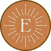 badge design of the elliott monogram on a textured rusty orange background with an antique bronze border
