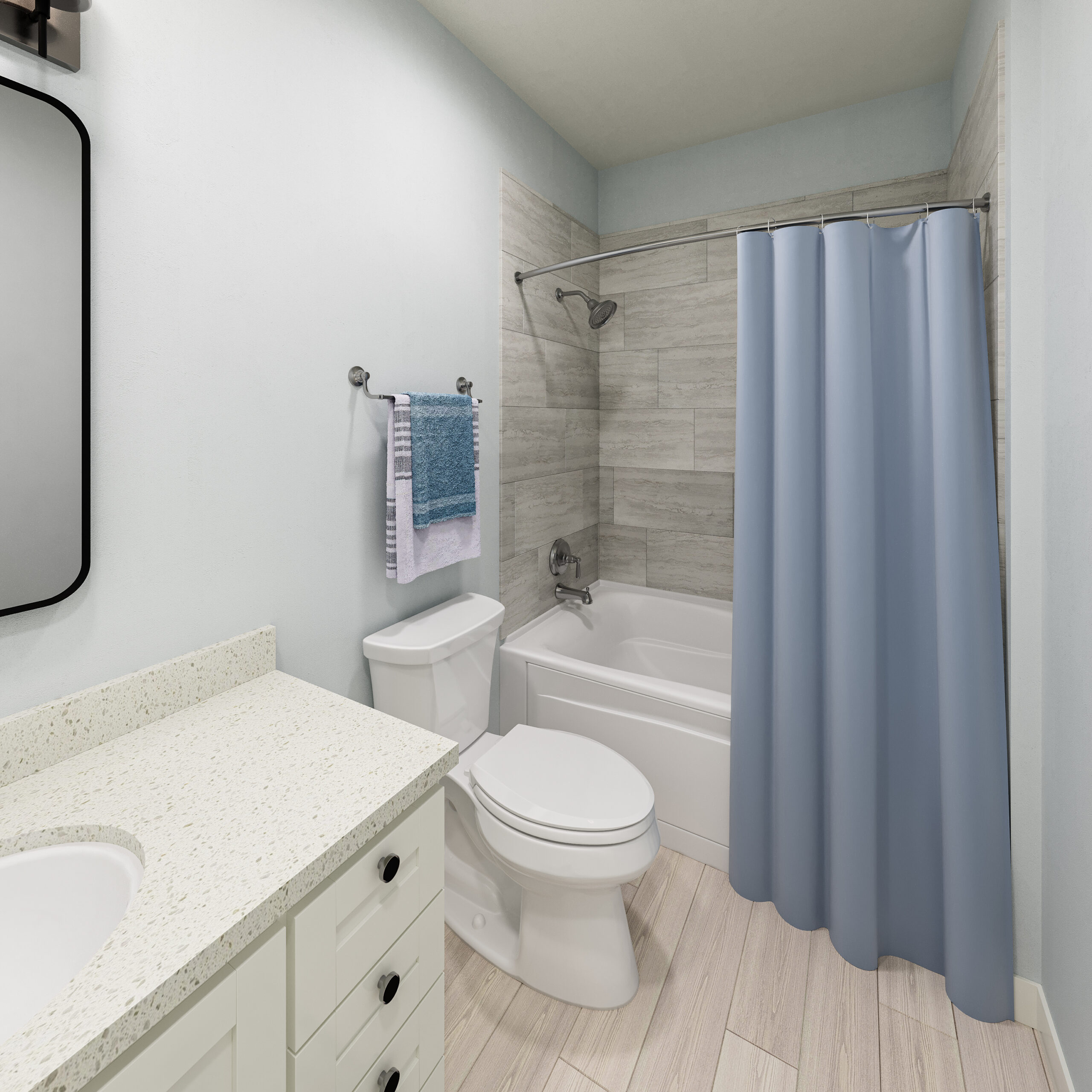 Luxury apartment bathroom with sink and vanity, storage cabinets below the countertop, and a bath/shower with curtain.