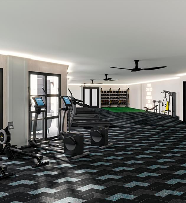 Fitness center with large windows, ceiling fan and workout machines.